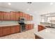 Well-equipped kitchen featuring wood cabinets, modern appliances, and ample counter space at 13617 W Crocus Dr, Surprise, AZ 85379