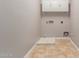 Laundry room with tile floor, storage cabinets, and washer and dryer hookups at 13617 W Crocus Dr, Surprise, AZ 85379