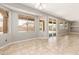 Cozy living area with tile flooring, multiple windows, and sliding glass doors that offer seamless indoor/outdoor living at 13617 W Crocus Dr, Surprise, AZ 85379