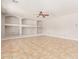 Large living room with tile flooring, recessed lighting, and built-in shelving at 13617 W Crocus Dr, Surprise, AZ 85379