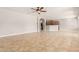 Open concept living room featuring tile floors, a ceiling fan, and an open kitchen at 13617 W Crocus Dr, Surprise, AZ 85379