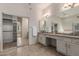 Bright bathroom with double vanity, large mirror, and access to closet at 14657 N 103Rd Way, Scottsdale, AZ 85255