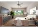 Staged bedroom with furniture, a view of the backyard, and a ceiling fan at 14657 N 103Rd Way, Scottsdale, AZ 85255