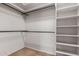 Walk-in closet with carpet flooring, shelving, and hanging rods at 14657 N 103Rd Way, Scottsdale, AZ 85255
