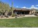 Community clubhouse featuring an outdoor patio, stone accents, and meticulously maintained landscaping at 14657 N 103Rd Way, Scottsdale, AZ 85255