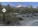 Desert landscape featuring local flora, mountain views and slow sign at 14657 N 103Rd Way, Scottsdale, AZ 85255