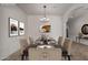 Virtually staged dining room featuring modern decor and a stylish table setting at 14657 N 103Rd Way, Scottsdale, AZ 85255