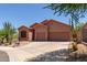 Single-story desert home with a spacious driveway and xeriscaped front yard at 14657 N 103Rd Way, Scottsdale, AZ 85255