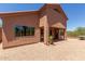 Exterior view showcasing the home's architecture, with windows reflecting the desert landscape at 14657 N 103Rd Way, Scottsdale, AZ 85255