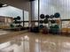 A fitness center with various exercise balls, mats, and chairs on a glossy wooden floor near large mirrors and windows at 14657 N 103Rd Way, Scottsdale, AZ 85255