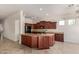 Bright kitchen with dark wood cabinets, granite countertops, and a functional center island with bar seating at 14657 N 103Rd Way, Scottsdale, AZ 85255