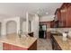 Spacious kitchen featuring granite countertops, a central island, and modern appliances at 14657 N 103Rd Way, Scottsdale, AZ 85255