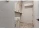 Bright laundry room with cabinets, sink, and tile flooring at 14657 N 103Rd Way, Scottsdale, AZ 85255