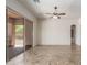 Bright living room featuring tiled floors, a ceiling fan, and large sliding doors leading to a covered patio at 14657 N 103Rd Way, Scottsdale, AZ 85255
