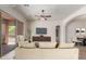 Staged living room shows a large sofa and TV with a door leading to a shaded back patio at 14657 N 103Rd Way, Scottsdale, AZ 85255