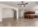 Spacious, tiled living room with open layout and arched entryways, leading to a dining and kitchen area at 14657 N 103Rd Way, Scottsdale, AZ 85255