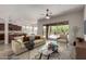Staged living room with a couch, chair, and glass coffee table showcasing the bright indoor/outdoor desert aesthetic at 14657 N 103Rd Way, Scottsdale, AZ 85255