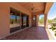 Covered patio with tiled flooring and sliding doors overlooking desert landscaping at 14657 N 103Rd Way, Scottsdale, AZ 85255