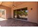 Covered patio with tiled flooring and sliding doors overlooking desert landscaping at 14657 N 103Rd Way, Scottsdale, AZ 85255