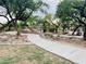 Community playground with green play structure, desert landscaping, and paved pathway at 14657 N 103Rd Way, Scottsdale, AZ 85255
