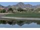 Picturesque pond reflecting mountains and nearby homes on a golf course at 14657 N 103Rd Way, Scottsdale, AZ 85255