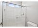 A modern bathroom featuring a glass-enclosed shower and tiled walls at 14870 W Encanto Blvd # 1091, Goodyear, AZ 85395