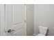 Neutral-toned half bathroom featuring a white toilet and modern door hardware at 14870 W Encanto Blvd # 1091, Goodyear, AZ 85395