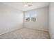 A cozy bedroom with carpeted floors, a ceiling fan and large windows providing natural light at 14870 W Encanto Blvd # 1091, Goodyear, AZ 85395