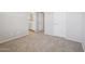 An empty bedroom with carpet and connecting bathroom featuring double sinks and a shower at 14870 W Encanto Blvd # 1091, Goodyear, AZ 85395