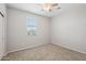 Bedroom with neutral carpet, ceiling fan, and one window at 14870 W Encanto Blvd # 1091, Goodyear, AZ 85395