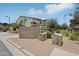 Two-story condo with tan stucco and a well-manicured lawn and garden at 14870 W Encanto Blvd # 1091, Goodyear, AZ 85395