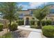 Charming two-story home with landscaped yard, walkway, and mature trees for curb appeal at 14870 W Encanto Blvd # 1091, Goodyear, AZ 85395