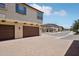 Spacious three-car garage with brick-paved driveway, set in a well-maintained community at 14870 W Encanto Blvd # 1091, Goodyear, AZ 85395