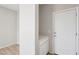 Bright hallway featuring a white cabinet and modern door leading to the garage at 14870 W Encanto Blvd # 1091, Goodyear, AZ 85395