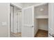 Hallway featuring an open closet, modern doors, and neutral decor at 14870 W Encanto Blvd # 1091, Goodyear, AZ 85395