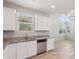 Open kitchen with white cabinets, granite counters, and stainless dishwasher at 14870 W Encanto Blvd # 1091, Goodyear, AZ 85395
