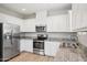 Bright kitchen featuring stainless steel appliances, white cabinets, and granite counters at 14870 W Encanto Blvd # 1091, Goodyear, AZ 85395