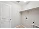 Laundry room with modern hookups, shelf and white door at 14870 W Encanto Blvd # 1091, Goodyear, AZ 85395