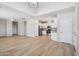 Bright, open-concept living space featuring wood-look floors and an adjacent kitchen with stainless steel appliances at 14870 W Encanto Blvd # 1091, Goodyear, AZ 85395