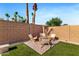 Charming backyard seating area with lush turf and brick privacy wall, ideal for relaxing and enjoying the outdoors at 1492 W Bruce Ave, Gilbert, AZ 85233