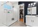 Modern bathroom featuring a glass shower with a rain shower head, white cabinets, and a walk-in closet at 1492 W Bruce Ave, Gilbert, AZ 85233