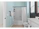 Bright bathroom with modern fixtures, blue walls, and a shower-tub combo with white shower curtain at 1492 W Bruce Ave, Gilbert, AZ 85233