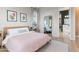 Cozy bedroom with light wood accents and a view into the ensuite bathroom and walk-in closet at 1492 W Bruce Ave, Gilbert, AZ 85233