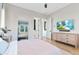 Inviting bedroom with a neutral color palette and a view into the ensuite bathroom at 1492 W Bruce Ave, Gilbert, AZ 85233