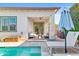 Stylish covered patio with modern seating overlooking the pool and serene backyard, ideal for outdoor entertaining at 1492 W Bruce Ave, Gilbert, AZ 85233