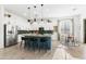 Spacious kitchen with stainless steel appliances, white cabinets, and a blue island with seating at 1492 W Bruce Ave, Gilbert, AZ 85233