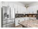 Well-equipped kitchen featuring a stainless steel refrigerator and granite countertops for a modern feel at 1492 W Bruce Ave, Gilbert, AZ 85233