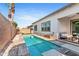 Relaxing pool and backyard oasis, perfect for summer fun and entertainment with palm trees and desert landscaping at 1492 W Bruce Ave, Gilbert, AZ 85233