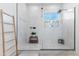 This stylish shower features white tiled walls, a glass enclosure, and modern fixtures at 1492 W Bruce Ave, Gilbert, AZ 85233