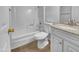 Bathroom featuring a tub, toilet, vanity, granite countertop, and white cabinets at 1750 E Mateo Cir # 103, Mesa, AZ 85204